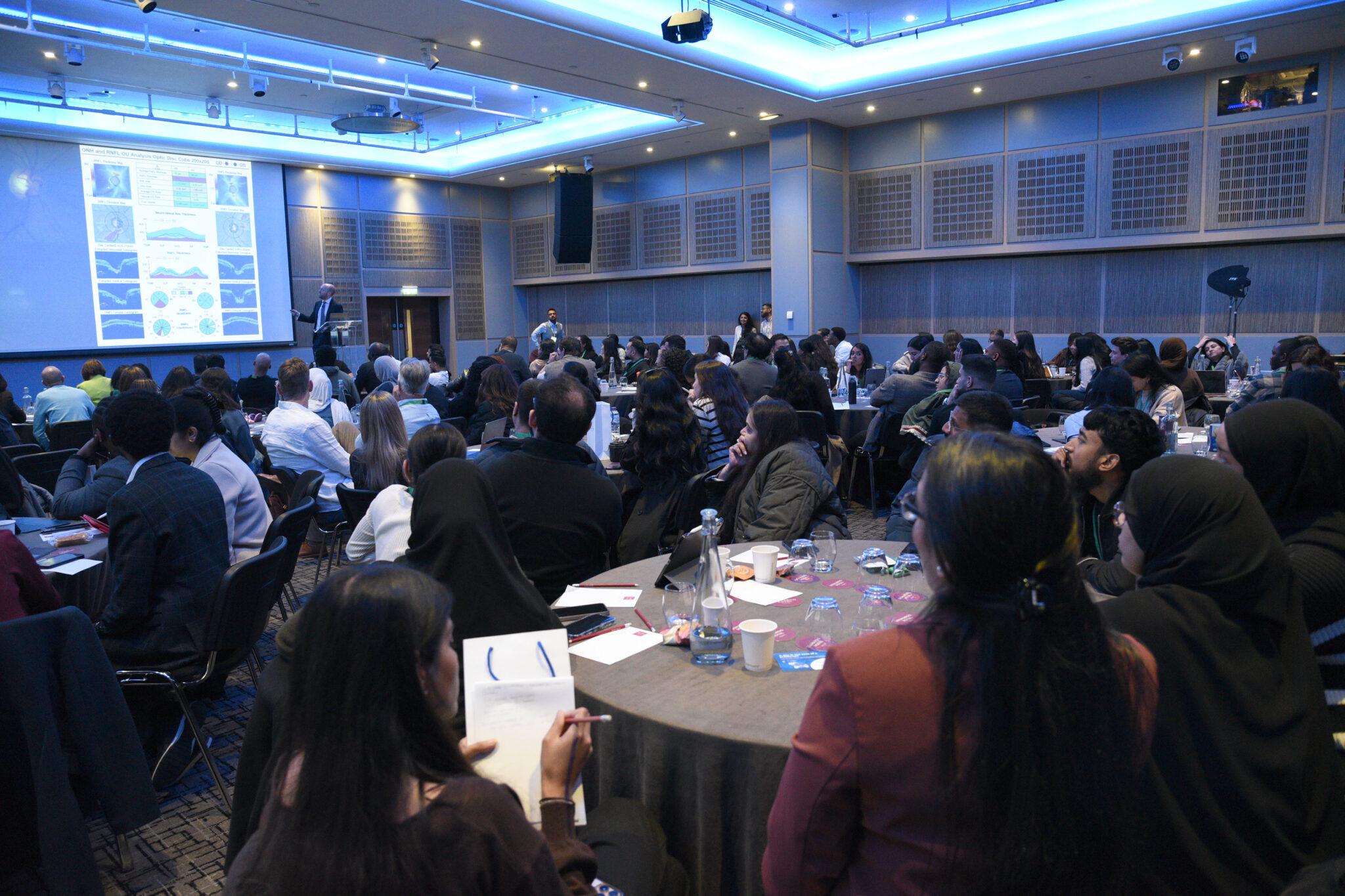 MiniPAC 2026 event with clinicians attending a presentation in a conference setting